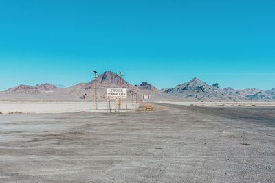 Scenic view of desert against clear blue sky