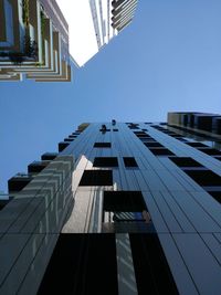 Low angle view of modern building against clear blue sky