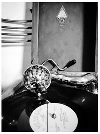 Close-up of clock on table at home