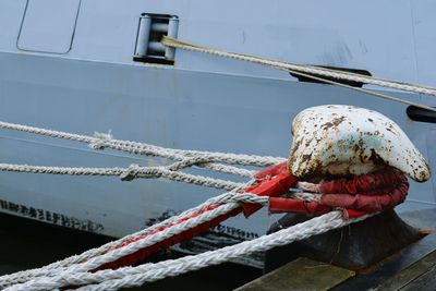 Close-up of rope tied to boat moored at harbor