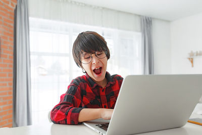 Young woman using laptop at home