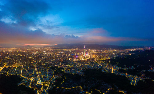 High angle view of illuminated city buildings at night