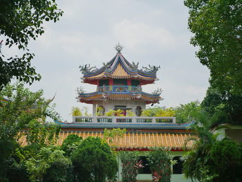 View of temple building against cloudy sky