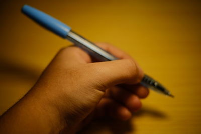 Close-up of person hand holding pen