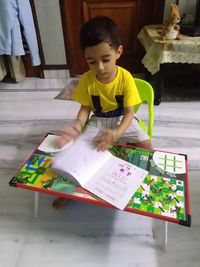 Full length of a boy holding book