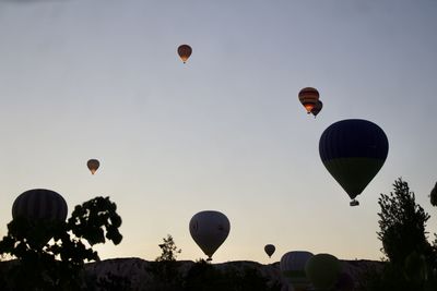 Low angle view of hot air balloons against sky during sunset