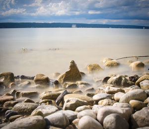 Rocks on beach against sky