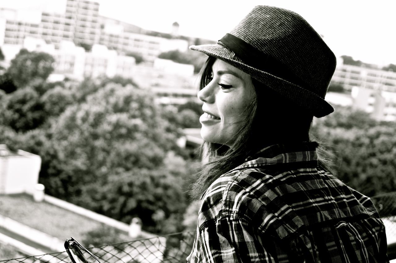 CLOSE-UP OF YOUNG WOMAN WITH HAT