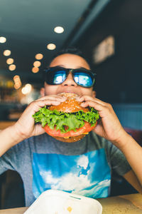 Close-up of boy eating hamburger