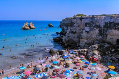 People on beach against sky