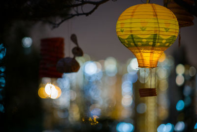 Low angle view of illuminated lanterns hanging at night