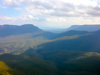 Scenic view of mountains against cloudy sky