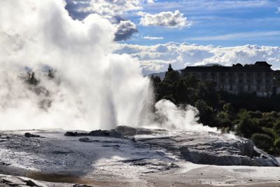 Scenic view of waterfall against sky