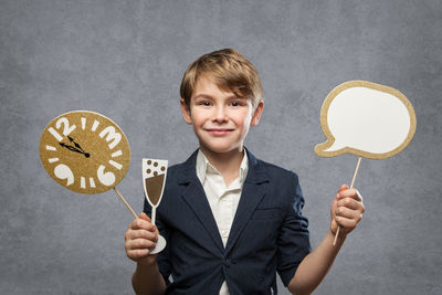 Portrait of smiling boy holding camera