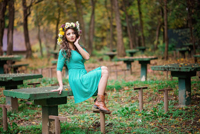 Portrait of woman sitting in forest