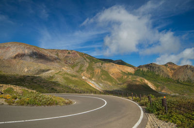 Empty road along rocky landscape