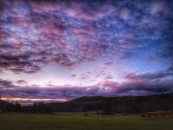 Scenic view of field against sky at sunset