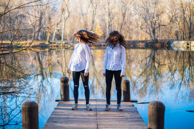 Friends standing at riverbank