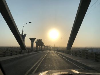 Street against sky during sunset