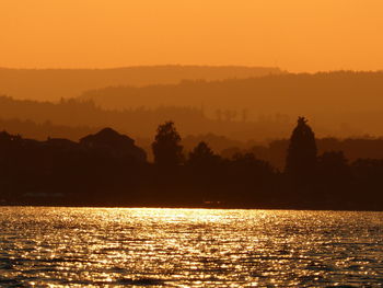 Scenic view of sea against orange sky