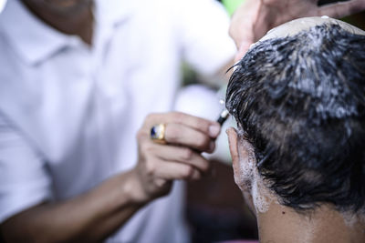 Close-up of man getting a haircut