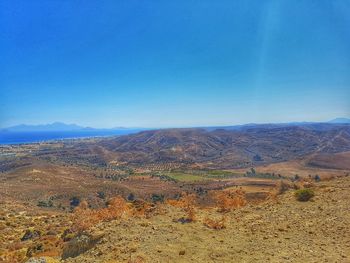 Scenic view of landscape against blue sky