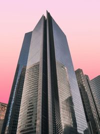 Low angle view of modern buildings against sky during sunset