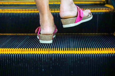 Low section of person wearing canvas shoes