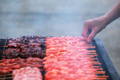 Midsection of man working on barbecue grill