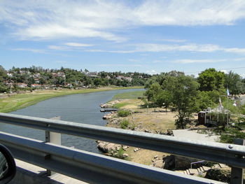 Scenic view of river against cloudy sky