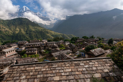 High angle view of old town against cloudy sky