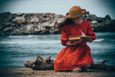 Woman holding umbrella on beach