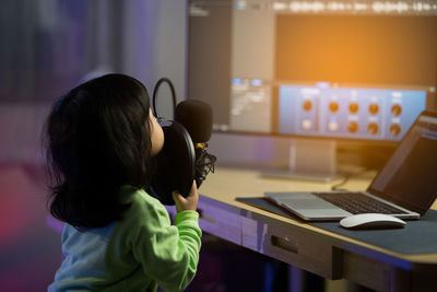 Close-up of of girl singing at studio