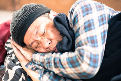 Close-up of beggar sleeping outdoors