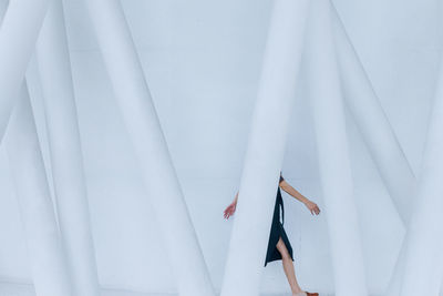 Close-up of woman standing on white curtain