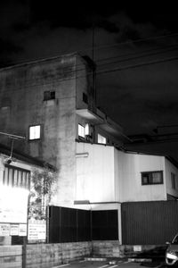 Low angle view of buildings against sky at night