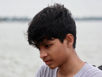 Portrait of young man looking at river 