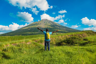 A hiker against the background of mount ol doinyo lengai in ngorongoro conservation area, tanzania