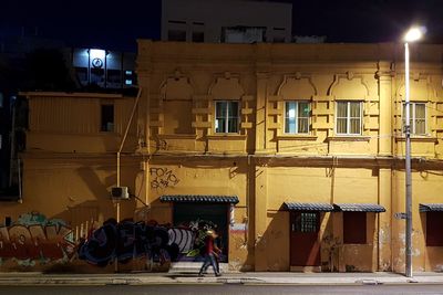 People in illuminated city at night