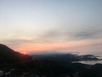 Scenic view of mountains against sky at sunset