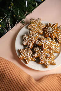 Ginger christmas cookies on the on a delicate peach background.