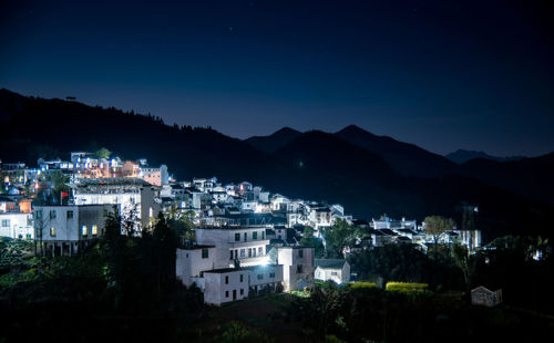 High angle view of illuminated buildings in city at night