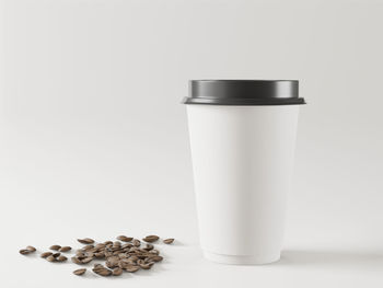 Close-up of coffee cup over white background