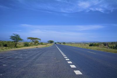 Road amidst trees against sky