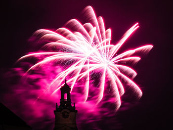 Low angle view of firework display at night