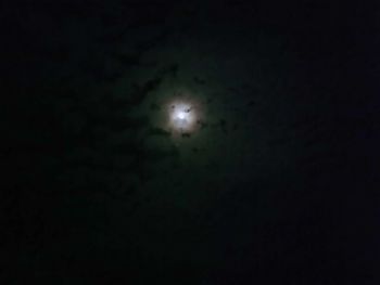 Low angle view of moon in sky at night