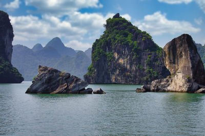 Scenic view of rocks in sea against sky