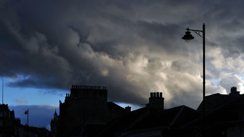 Low angle view of building against cloudy sky