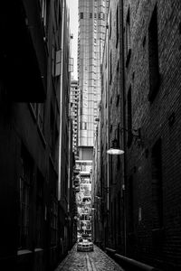 Narrow alley amidst buildings in city