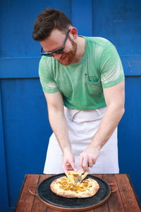 Man looking away while standing on table